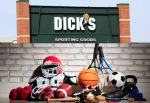 DICKS Sporting Goods | Where Loyalty Meets Legacy DICKS Sporting Goods sign above various sports equipment including a football helmet, basketball, soccer ball, gloves, and tennis rackets.