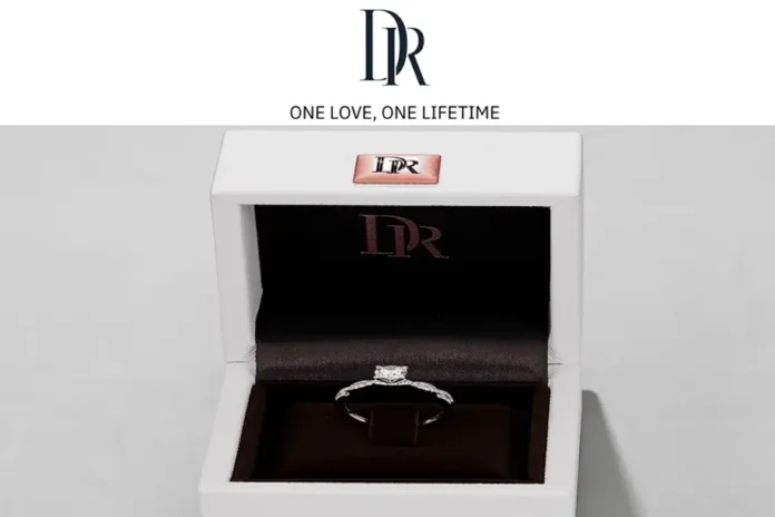 A Darry Ring presented in a white box, inscribed with 