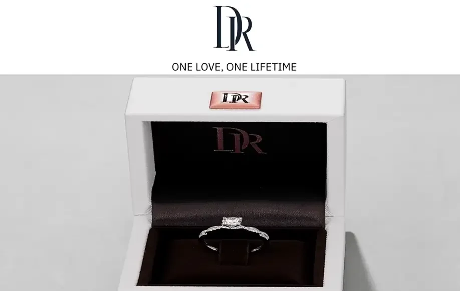 A Darry Ring presented in a white box, inscribed with 