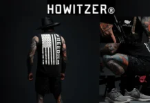 Howitzer Clothing | 5 Must-Have Pieces for the Bold & Brave Model wearing Howitzer Clothing with patriotic “FREEDOM” tank top, showcasing bold tattoos and tactical-inspired streetwear.
