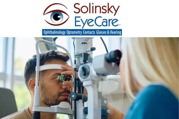 Solinsky EyeCare LLC eye exam with male patient undergoing vision test using diagnostic equipment by female optometrist.