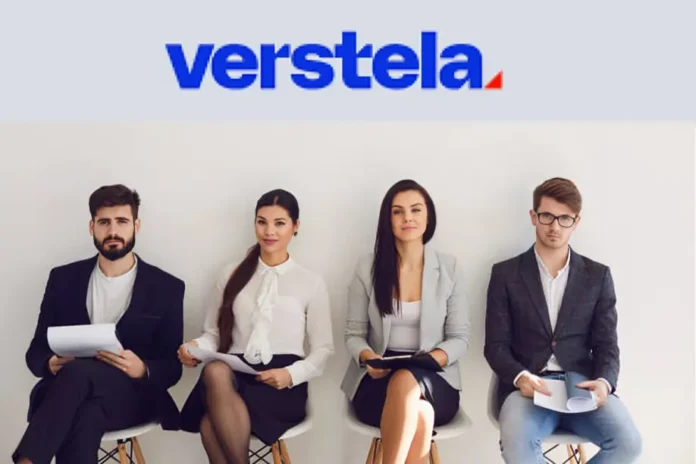 Verstela job candidates seated in a row, dressed professionally, holding resumes while waiting for interviews.