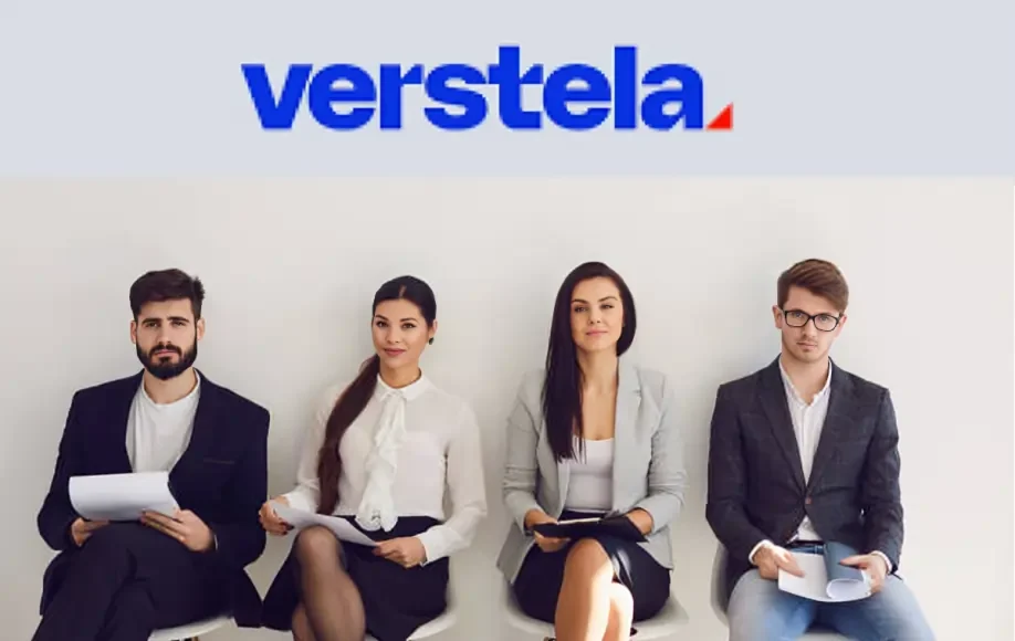 Verstela job candidates seated in a row, dressed professionally, holding resumes while waiting for interviews.