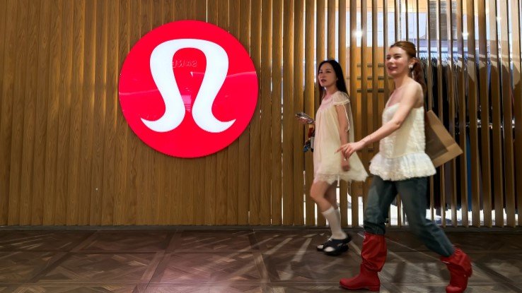 Shoppers walk past a Lululemon store at a shopping mall on June 21, 2026, in Hong Kong, China.