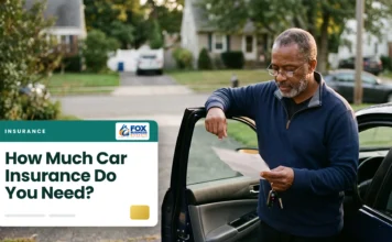 How Much Car Insurance Do You Need? A Guide to the Right Coverage and Limits Man reviewing how much car insurance he needs beside his open car door in a suburban driveway