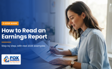 How to Read an Earnings Report: 7 Simple Steps A woman reviewing a printed quarterly financial report with a pen, with a bar chart on her laptop screen.