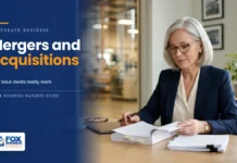 Mergers and Acquisitions: How M&A Deals Really Work Company founder reviewing a purchase agreement before selling her business, illustrating mergers and acquisitions